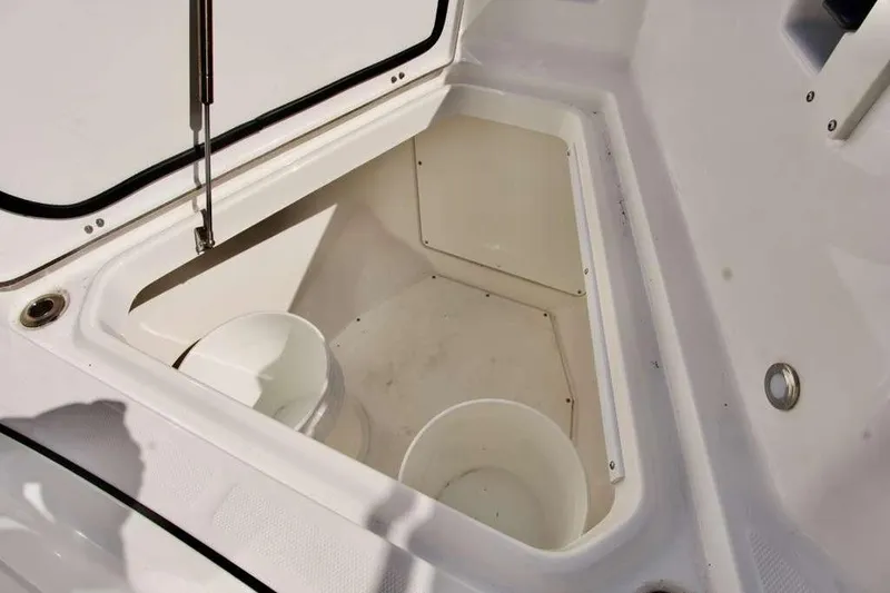 Slide: The Image of 2023 Blackfin 302 CC boat storage compartment with open hatch and buckets. - 40