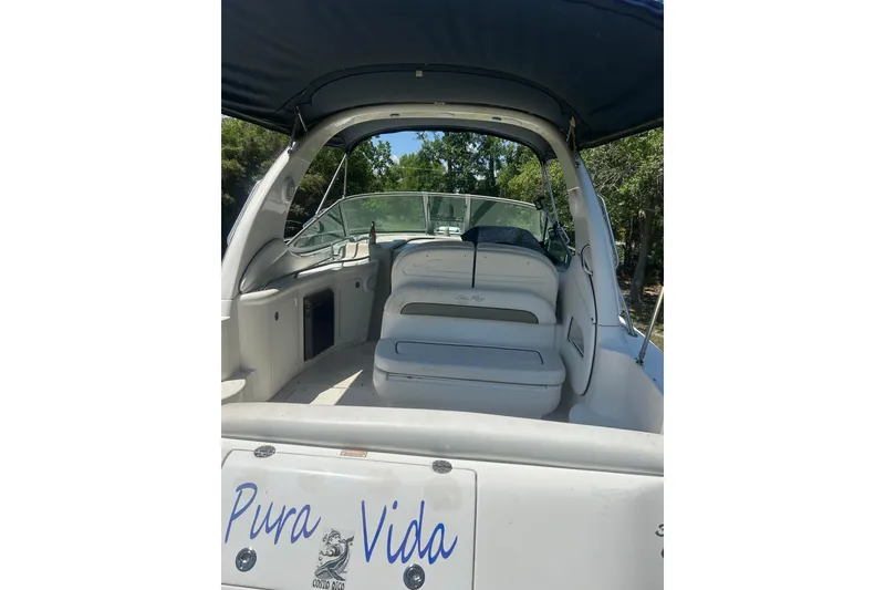 Slide: The Image of 2006 Sea Ray 300 Sundancer boat interior with seating, labeled "Pura Vida." - 14