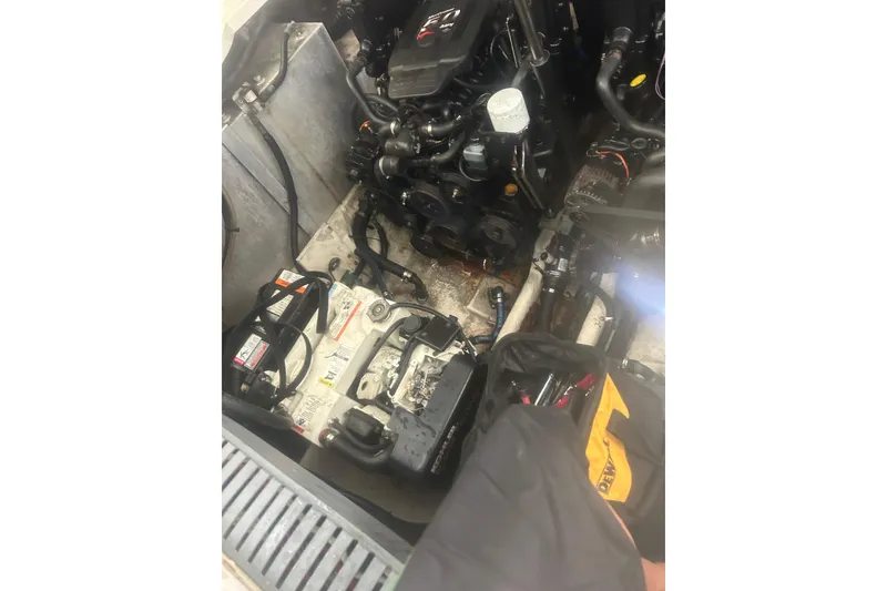 Slide: The Image of Engine compartment of a 2006 Sea Ray 300 Sundancer boat, showing battery and components. - 18
