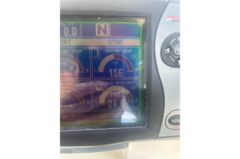 Slide: The Image of Display panel of a 2006 Sea Ray 300 Sundancer showing engine temperature and pressure readings. - 24