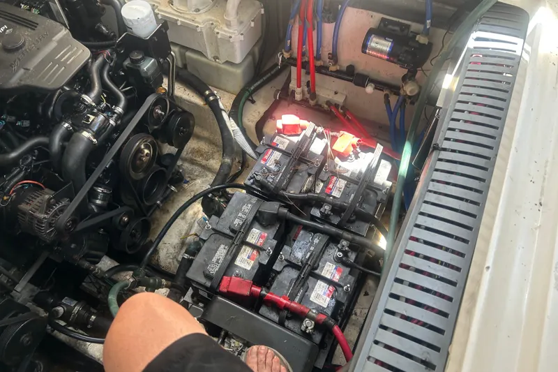 Slide: The Image of Engine compartment of a 2006 Sea Ray 300 Sundancer with visible batteries and wiring. - 25