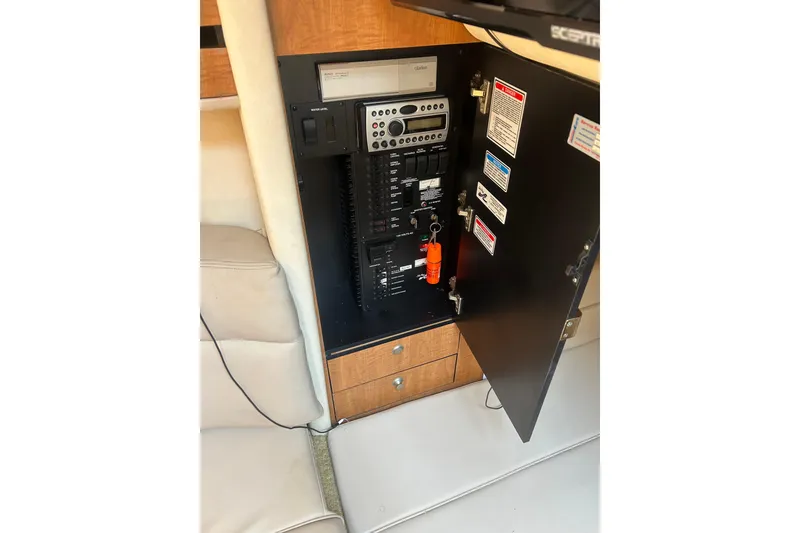 Slide: The Image of Electrical panel inside 2006 Sea Ray 300 Sundancer boat, featuring control switches and labels. - 27