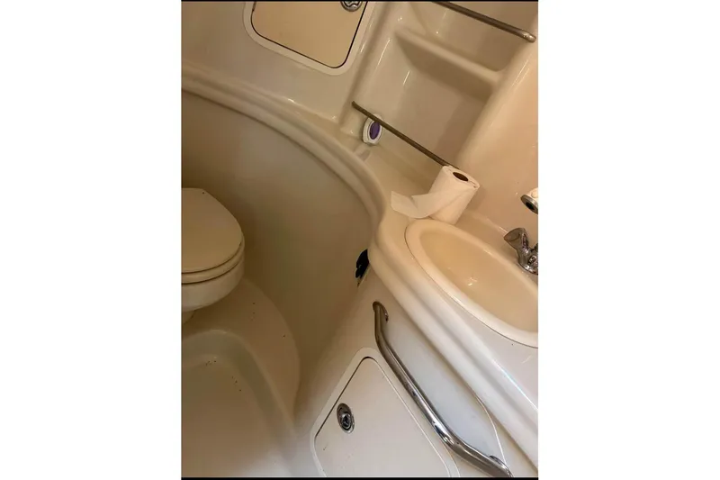 Slide: The Image of Bathroom interior of 2006 Sea Ray 300 Sundancer yacht, featuring toilet and sink. - 30