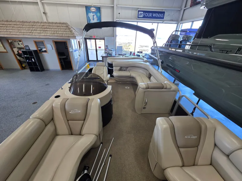 Slide: The Image of Interior view of a 2012 Sylvan Mirage 8522 pontoon boat in showroom. - 3