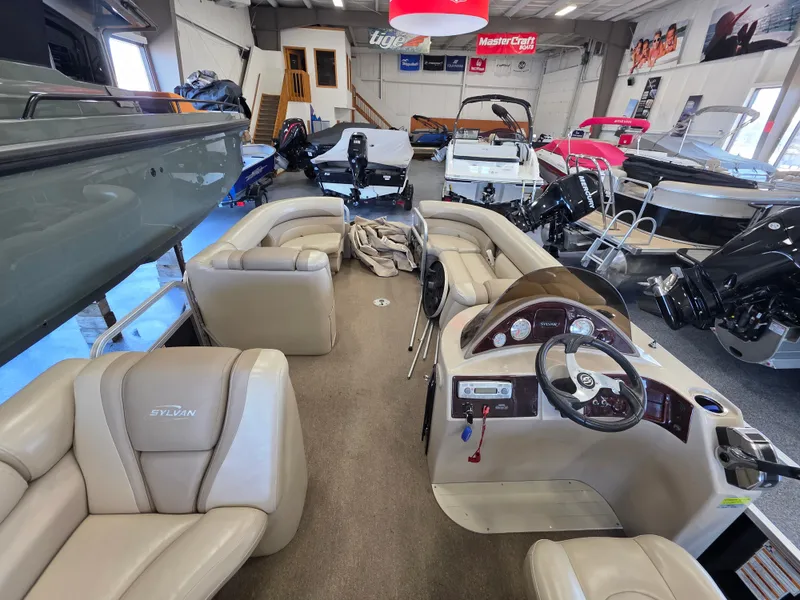 Slide: The Image of Interior view of a 2012 Sylvan Mirage 8522 pontoon boat in showroom. - 4