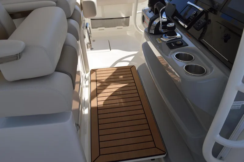 Slide: The Image of 2018 Boston Whaler 420 Outrage helm area with seating and control panel. - 11