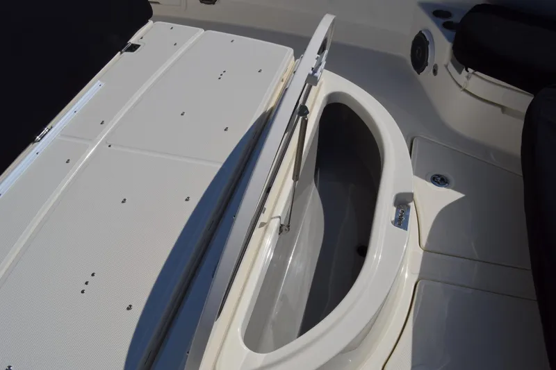 Slide: The Image of 2018 Boston Whaler 420 Outrage boat storage compartment open, showcasing interior space. - 13