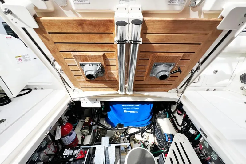 Slide: The Image of 2018 Boston Whaler 420 Outrage engine compartment with wooden paneling and equipment. - 15