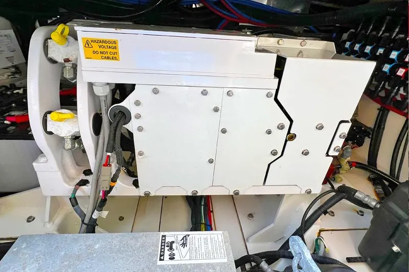 Slide: The Image of Electrical system of a 2018 Boston Whaler 420 Outrage boat, featuring cables and warning labels. - 16