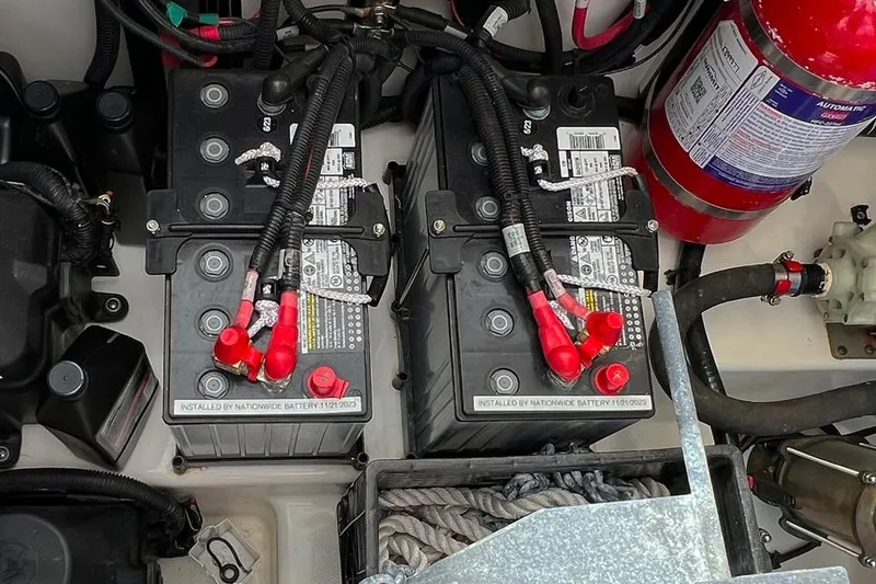 Slide: The Image of 2018 Boston Whaler 420 Outrage battery compartment with fire extinguisher and wiring. - 18