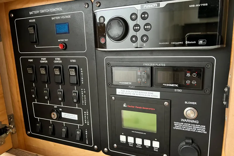 Slide: The Image of Control panel of a 2018 Boston Whaler 420 Outrage boat with various switches and displays. - 20