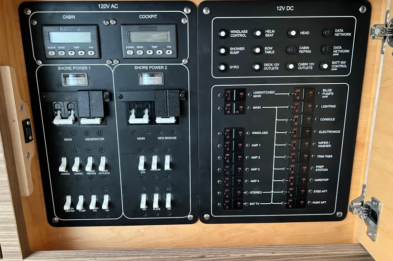 Slide: The Image of Electrical control panel of a 2018 Boston Whaler 420 Outrage boat, featuring switches and circuit breakers. - 22