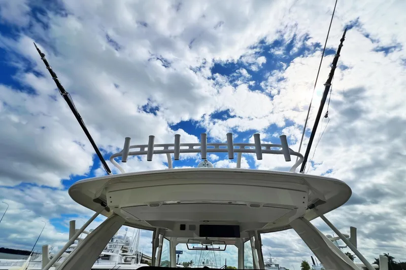 Slide: The Image of 2018 Boston Whaler 420 Outrage boat under cloudy sky with fishing rods. - 24