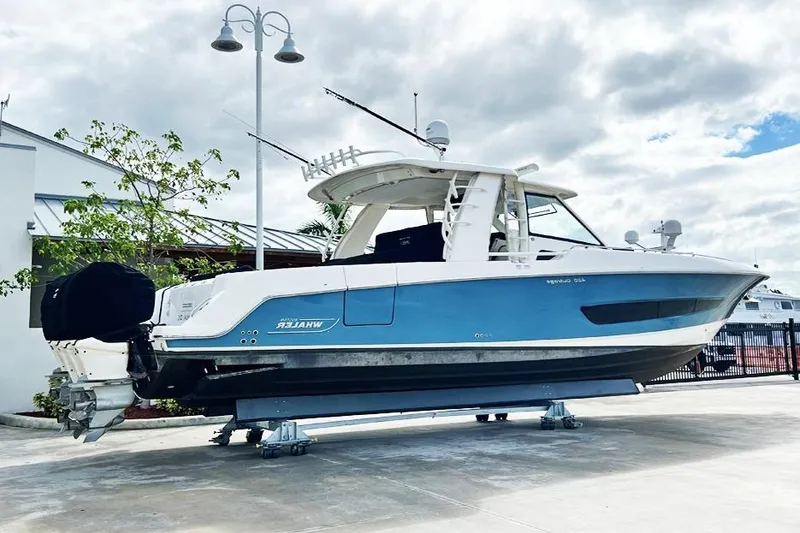 Slide: The Image of 2018 Boston Whaler 420 Outrage boat on display, blue and white exterior. - 27