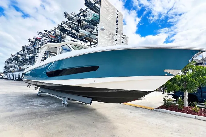 Slide: The Image of 2018 Boston Whaler 420 Outrage boat in storage, blue sky background. - 28