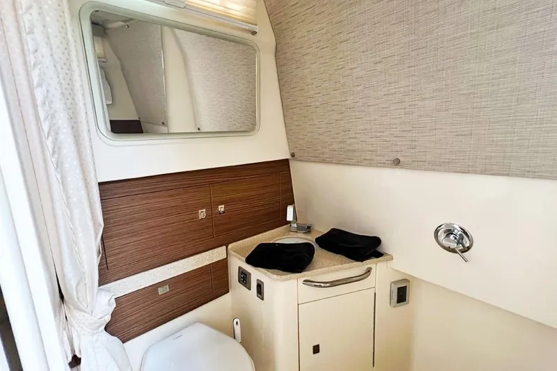 Slide: The Image of Interior of 2018 Boston Whaler 420 Outrage bathroom with sink, mirror, and storage. - 3