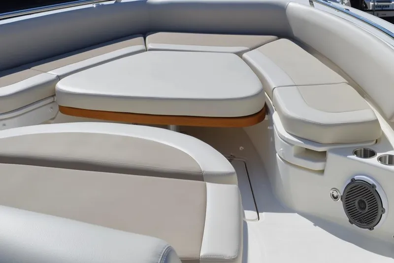 Slide: The Image of 2018 Boston Whaler 420 Outrage boat seating area with cushioned seats and cup holders. - 4