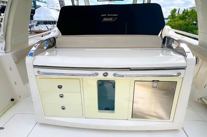 Slide: The Image of 2018 Boston Whaler 420 Outrage boat interior with storage and seating area. - 7