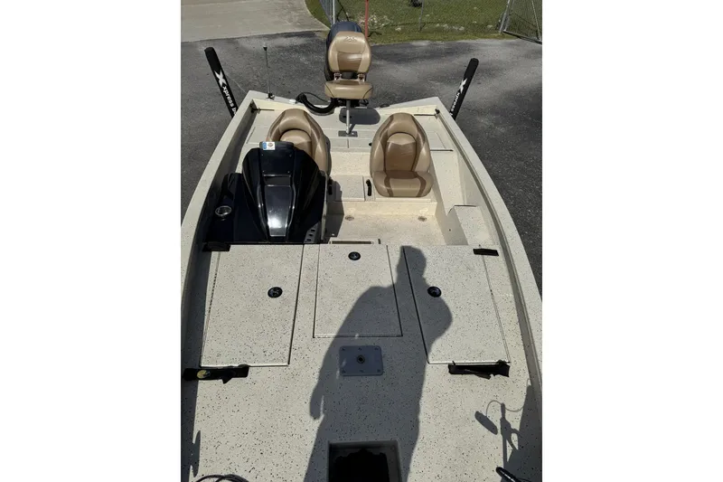 Slide: The Image of 2019 Xpress X17 Pro boat interior with beige seats and storage compartments. - 6