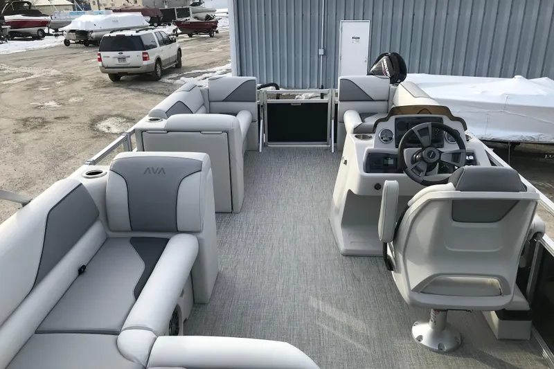 Slide: The Image of 2026 Avalon Venture Cruise Rear Bench boat interior with modern seating and steering console. - 15