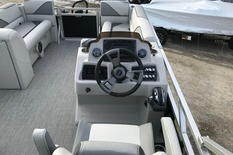 Slide: The Image of 2026 Avalon Venture Cruise Rear Bench boat interior with steering console and seating. - 16