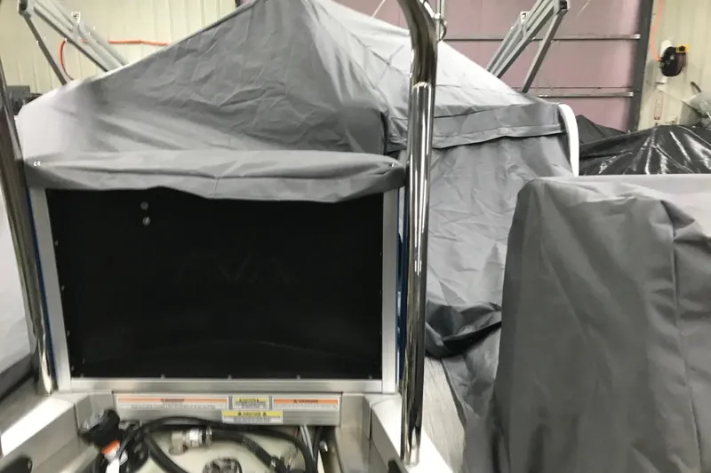 Slide: The Image of 2026 Avalon Venture Cruise Rear Bench covered in protective tarp in a garage setting. - 17