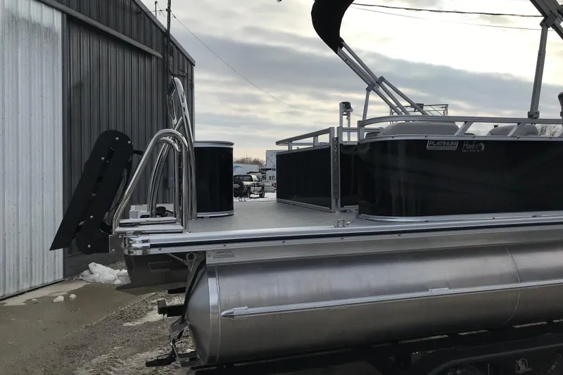 Slide: The Image of 2026 Avalon Venture Cruise Rear Bench pontoon boat at dockside, featuring sleek design. - 7