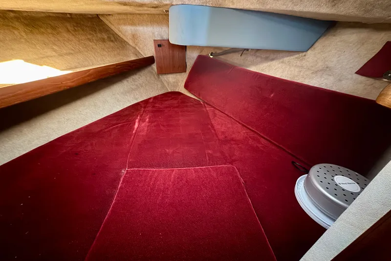 Slide: The Image of Interior cabin of 1989 Bayliner 3288 Motoryacht with red upholstery and storage space. - 12