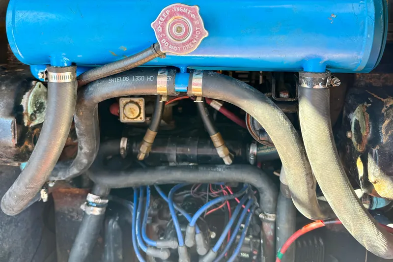 Slide: The Image of Engine compartment of a 1989 Bayliner 3288 Motoryacht, showing hoses and components. - 18