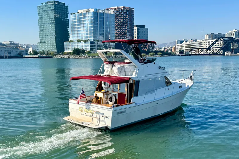 Slide: The Image of 1989 Bayliner 3288 Motoryacht cruising in urban waterfront setting. - 3