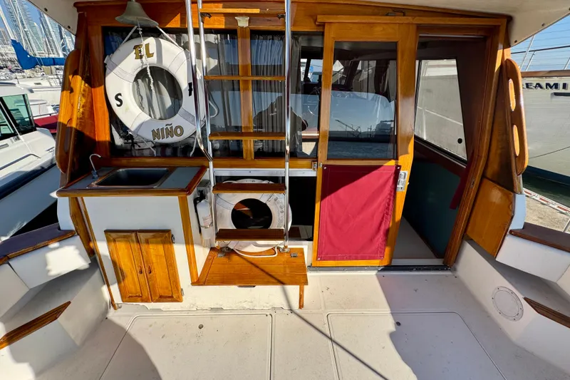 Slide: The Image of 1989 Bayliner 3288 Motoryacht interior with wooden accents and nautical decor. - 5