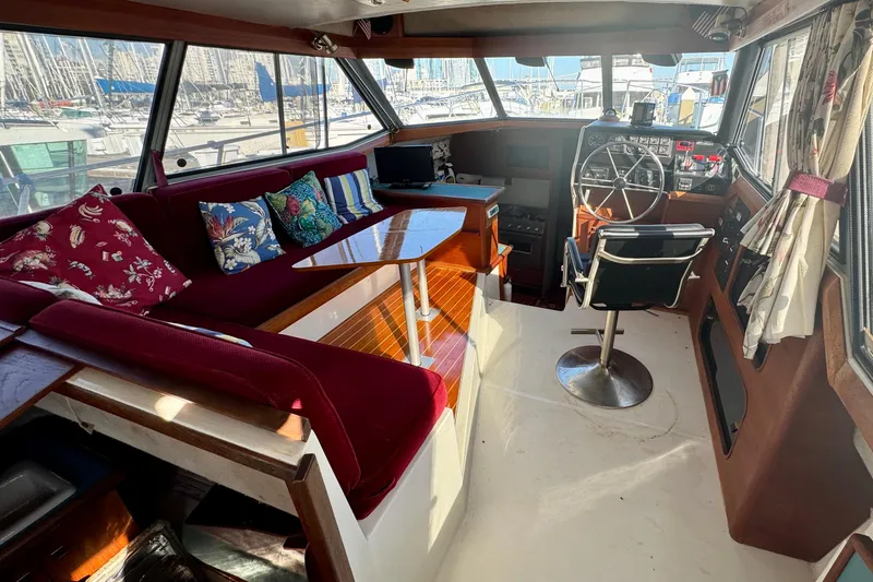 Slide: The Image of 1989 Bayliner 3288 Motoryacht interior with helm, seating, and colorful cushions. - 6