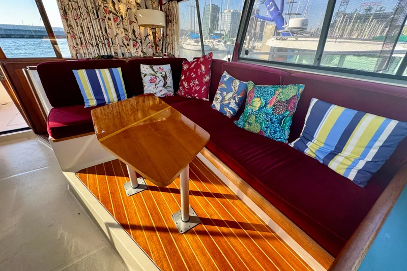 Slide: The Image of Interior of 1989 Bayliner 3288 Motoryacht with colorful cushions and wooden table. - 8