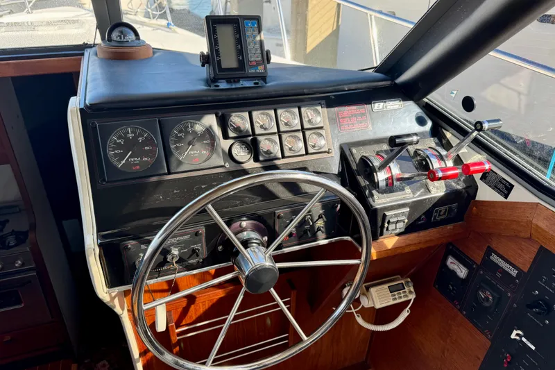 Slide: The Image of 1989 Bayliner 3288 Motoryacht helm with steering wheel, gauges, and controls. - 9