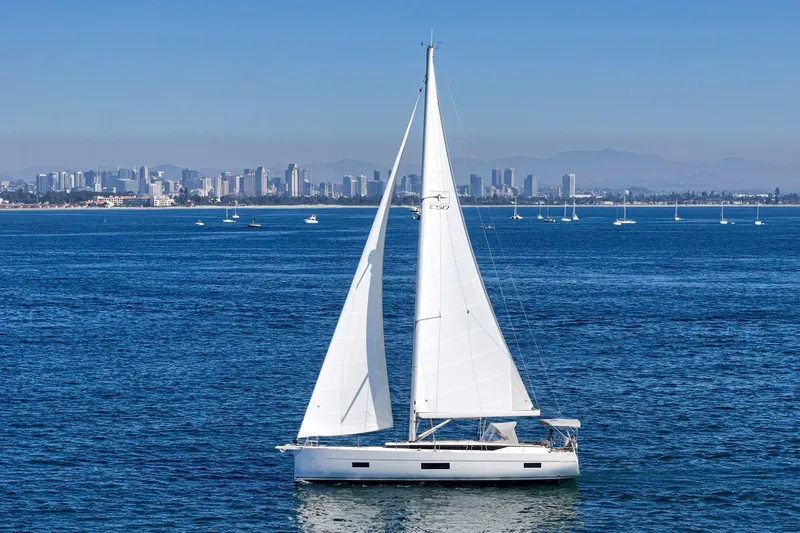 Slide: The Image of 2023 Bavaria C50 sailboat on ocean with city skyline in background. - 10
