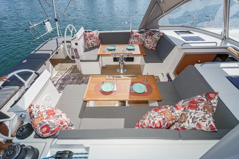 Slide: The Image of Luxurious 2023 Bavaria C50 yacht deck with elegant seating and dining setup. - 15