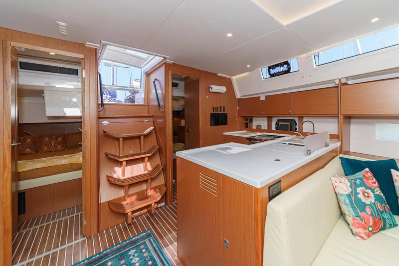 Slide: The Image of 2023 Bavaria C50 yacht interior with modern kitchen, cozy seating, and wooden finishes. - 32