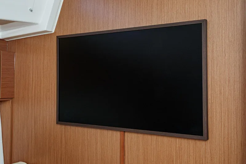 Slide: The Image of Flat-screen TV on wooden wall inside 2023 Bavaria C50 yacht interior. - 43