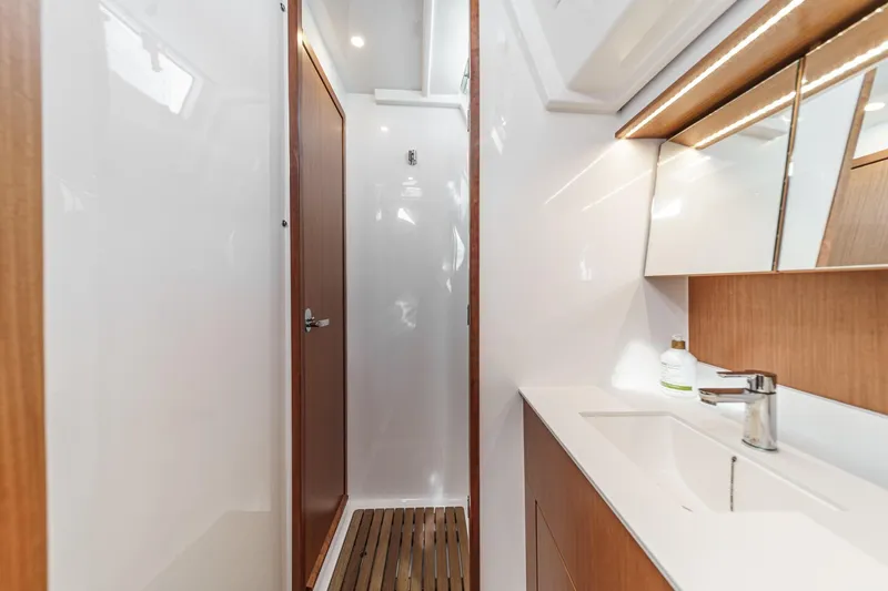 Slide: The Image of Modern bathroom interior of 2023 Bavaria C50 yacht, featuring sleek design and wooden accents. - 50