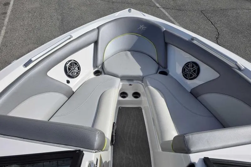 Slide: The Image of 2017 MasterCraft XT23 boat interior with gray seating and built-in speakers. - 11