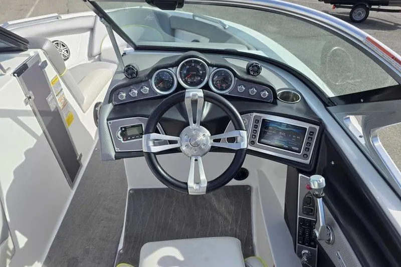 Slide: The Image of 2017 MasterCraft XT23 boat interior with steering wheel and dashboard controls. - 13