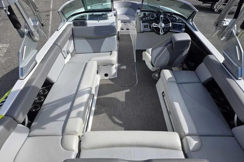 Slide: The Image of 2017 MasterCraft XT23 boat interior with spacious seating and modern dashboard. - 7