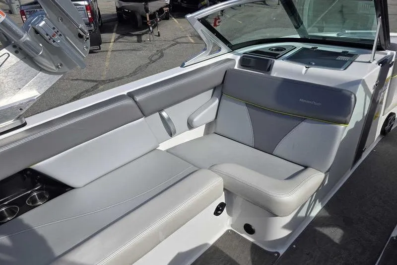 Slide: The Image of 2017 MasterCraft XT23 boat interior with gray seating and cup holders. - 9