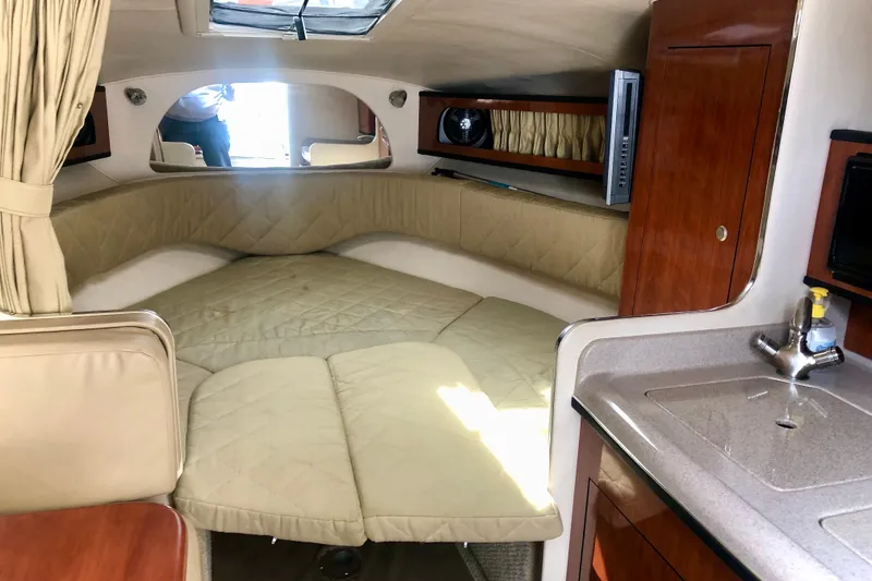 Slide: The Image of Interior of 2007 Sea Ray 280 Sundancer with cozy cabin and kitchenette. - 4