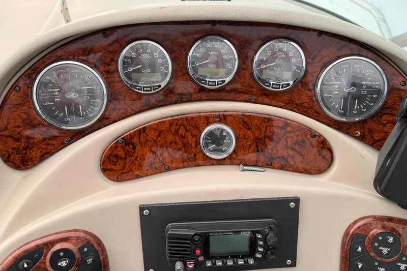 Slide: The Image of Dashboard of a 2007 Sea Ray Sundancer 280 boat with wood paneling and gauges. - 15