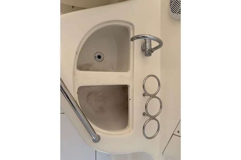 Slide: The Image of 2007 Sea Ray Sundancer 280 boat sink with faucet and cup holders. - 11