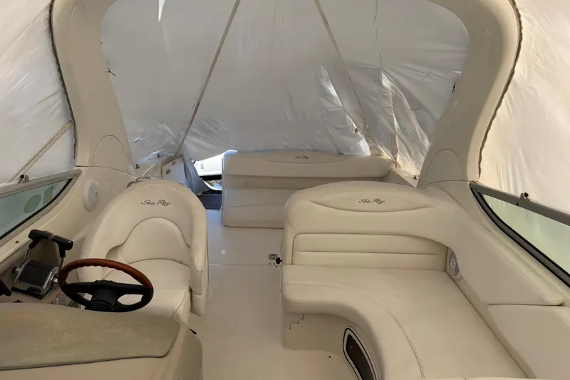 Slide: The Image of Interior of a 2007 Sea Ray Sundancer 280 boat with white seating and steering wheel. - 8