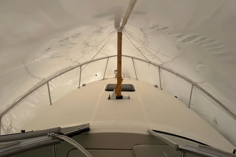 Slide: The Image of 2007 Sea Ray Sundancer 280 under protective cover, showcasing deck and support structure. - 10