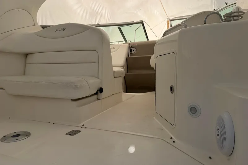 Slide: The Image of 2007 Sea Ray Sundancer 280 interior with beige seating and dashboard details. - 7
