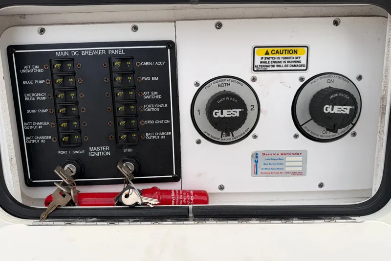 Slide: The Image of Main DC breaker panel of 2007 Sea Ray Sundancer 280 boat with ignition keys and switches. - 17